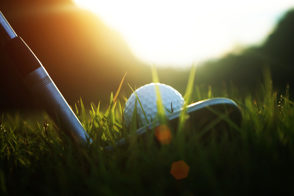 close up of a golf ball on a tee