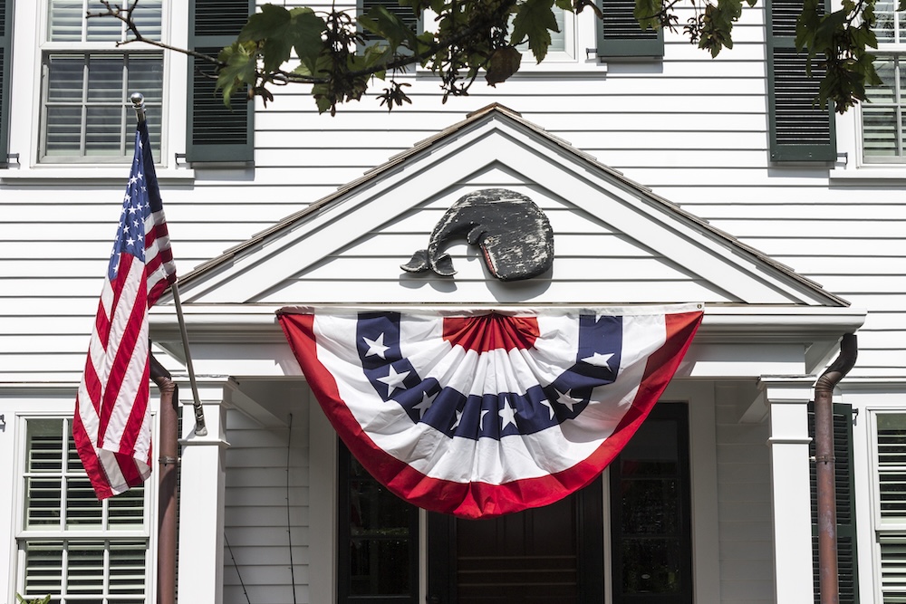 american flags hanging outside a martha's vineyard home