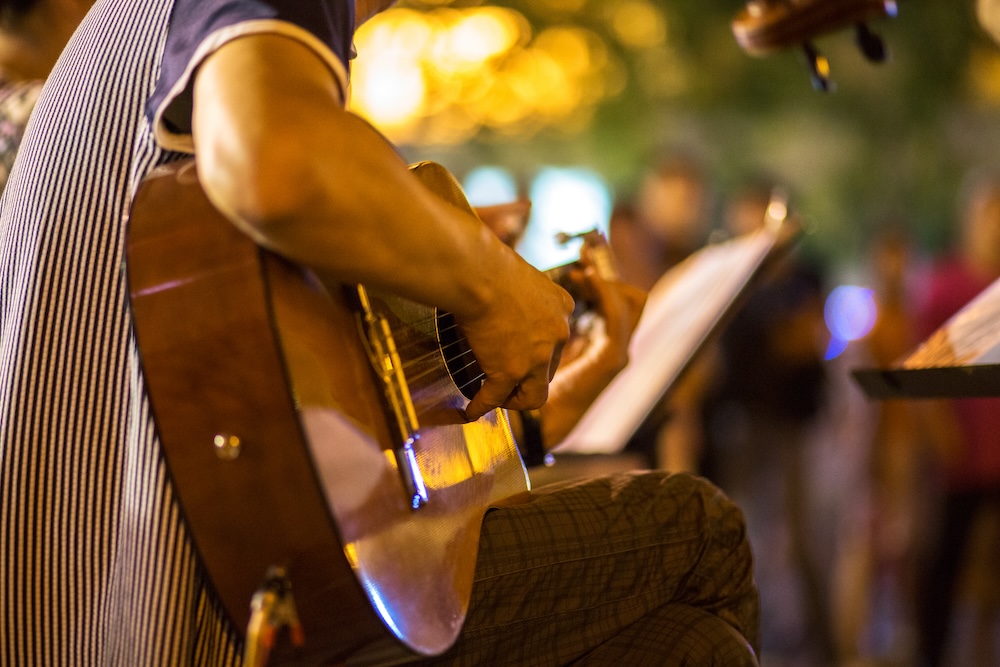 guitar player on stage outdoors